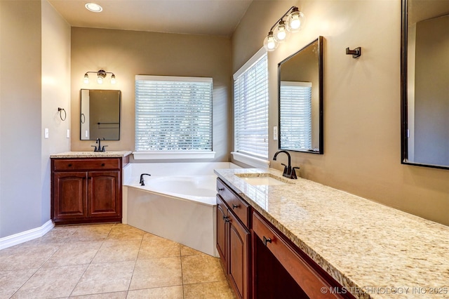 bathroom featuring a bathtub, tile patterned floors, and vanity