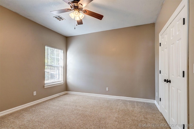 carpeted empty room with ceiling fan