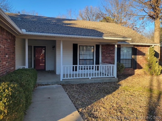 view of exterior entry featuring a porch