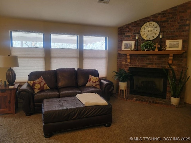 carpeted living room featuring vaulted ceiling and a fireplace