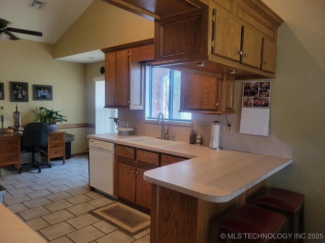 kitchen featuring kitchen peninsula, light tile patterned flooring, dishwasher, vaulted ceiling, and sink