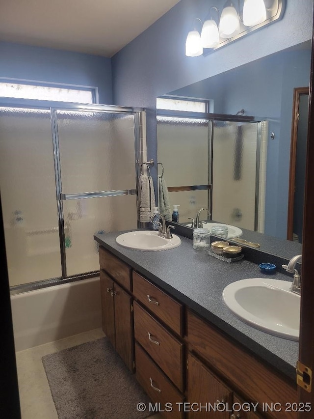 bathroom with combined bath / shower with glass door and vanity