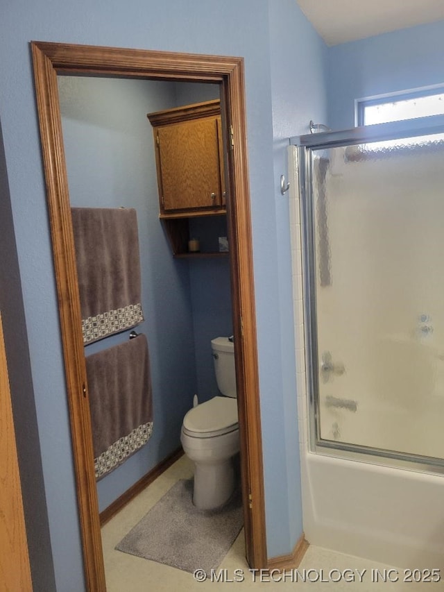 bathroom featuring toilet and enclosed tub / shower combo