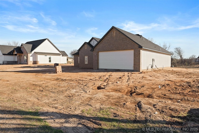 view of home's exterior with a garage and brick siding