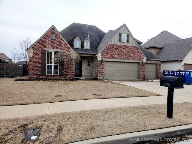 view of front of house with a garage, driveway, brick siding, and a shingled roof