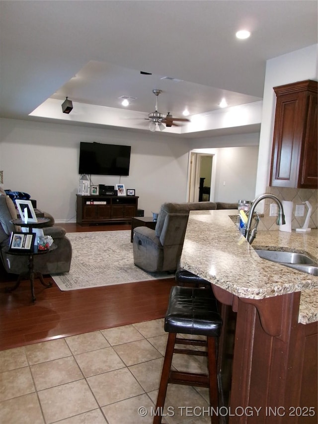 10500 W 123rd Rd, Oktaha, OK 74450 - living room with ceiling fan, light tile patterned floors, sink, and a raised ceiling