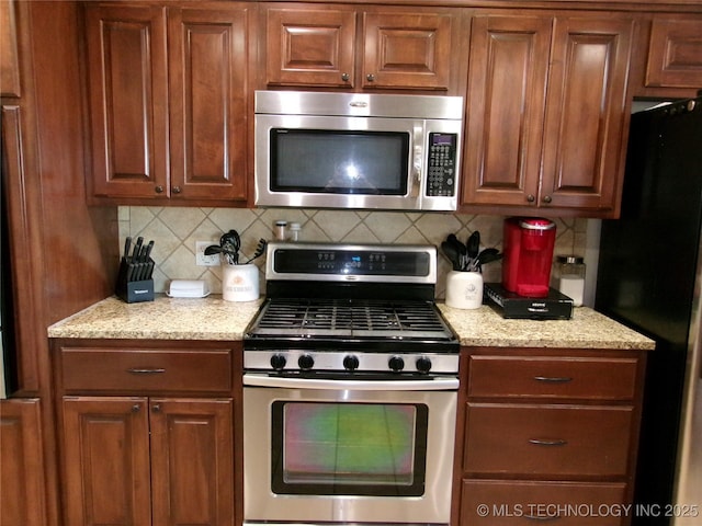 10500 W 123rd Rd, Oktaha, OK 74450 - kitchen featuring tasteful backsplash, light stone countertops, and appliances with stainless steel finishes