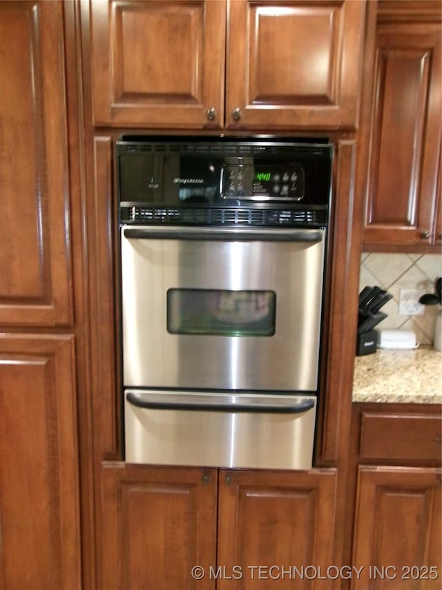 10500 W 123rd Rd, Oktaha, OK 74450 - kitchen featuring decorative backsplash, light stone counters, and stainless steel double oven