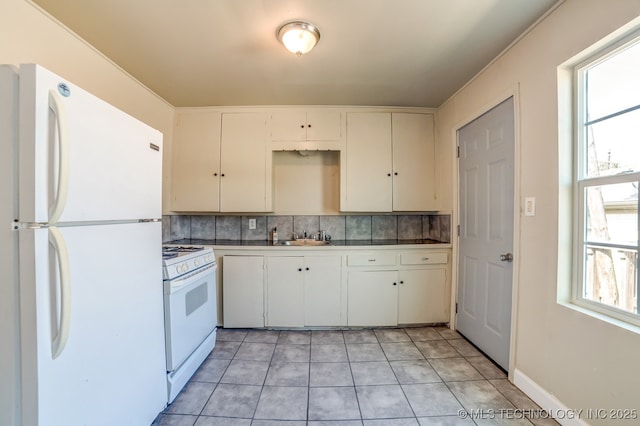 kitchen featuring backsplash, a wealth of natural light, white appliances, and white cabinetry