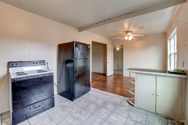 kitchen with ceiling fan, electric stove, light tile patterned floors, and black fridge