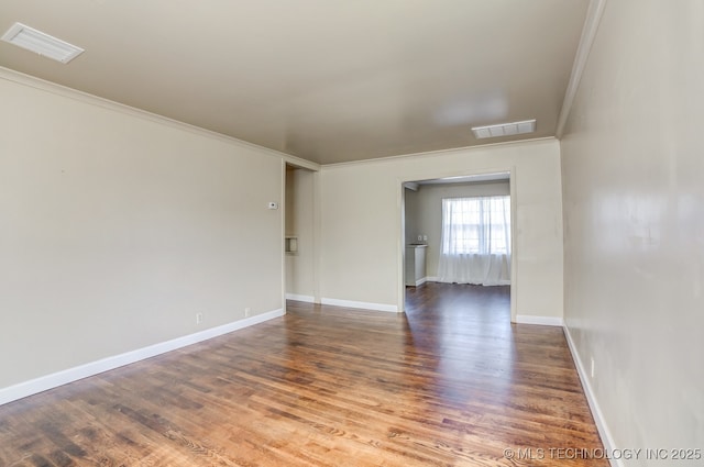 empty room with dark hardwood / wood-style floors and ornamental molding