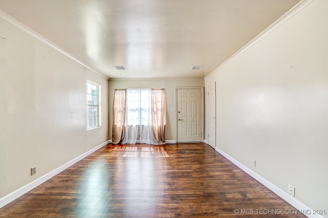 unfurnished room with dark wood-type flooring and ornamental molding