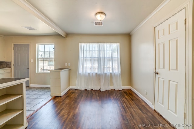 unfurnished dining area with dark wood-type flooring and crown molding