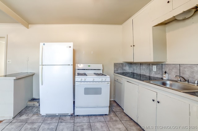 kitchen with white appliances, white cabinets, tasteful backsplash, sink, and light tile patterned flooring