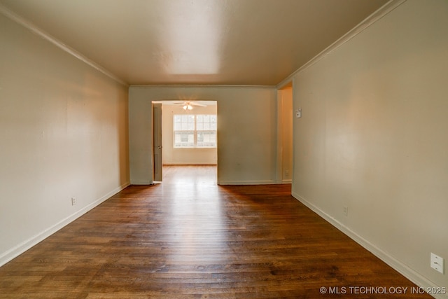 spare room with dark wood-type flooring, ceiling fan, and crown molding