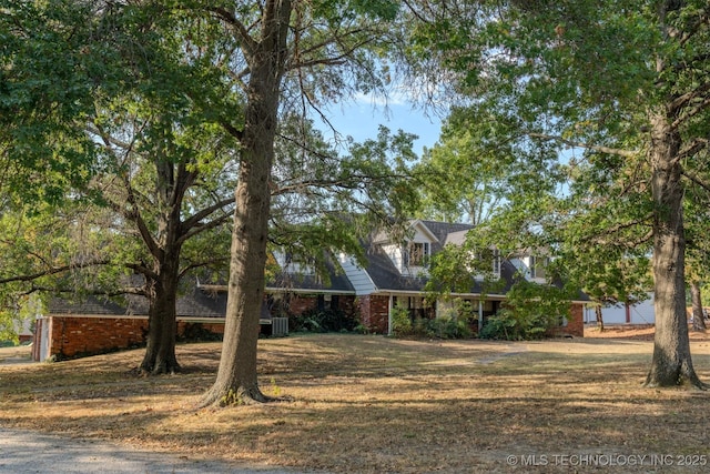 cape cod home with a front lawn and brick siding