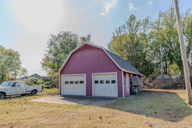 garage featuring a lawn