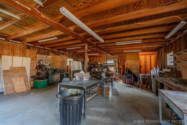 interior space with a workshop area and refrigerator