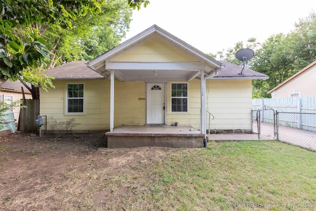 bungalow-style home featuring a front lawn