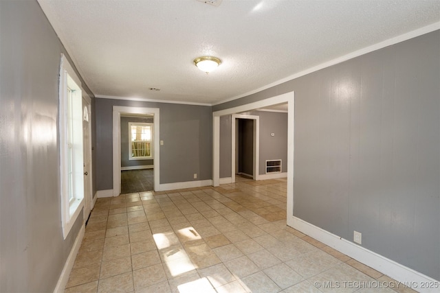 unfurnished room featuring a textured ceiling and crown molding