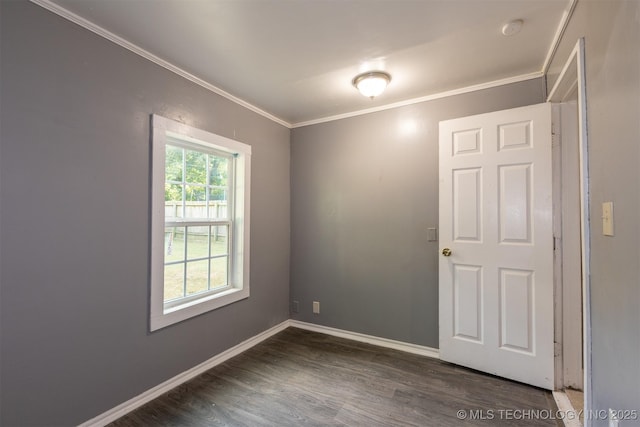 empty room featuring dark hardwood / wood-style flooring and crown molding