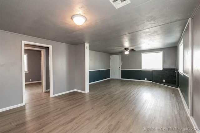 spare room with ceiling fan, a textured ceiling, and hardwood / wood-style floors