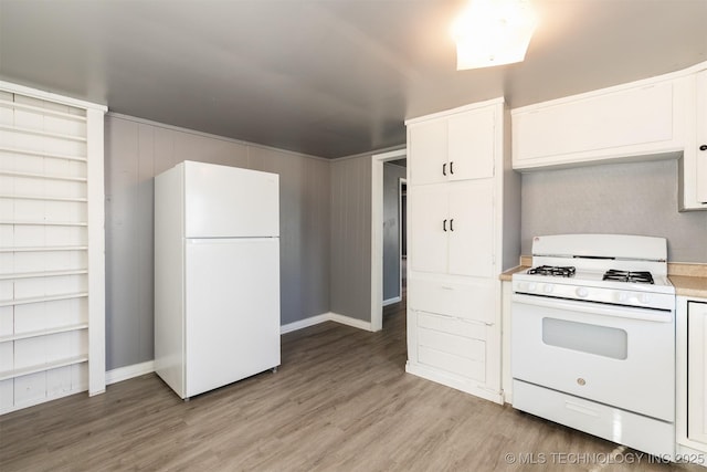 kitchen featuring white appliances, white cabinets, and light hardwood / wood-style flooring