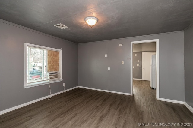 unfurnished room with dark hardwood / wood-style flooring and ornamental molding