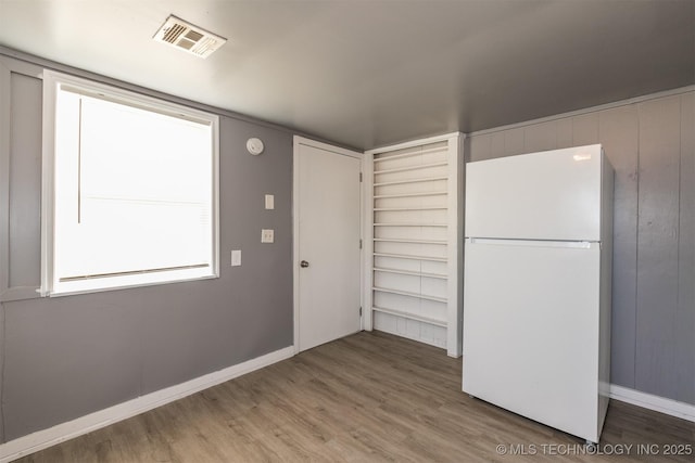 kitchen featuring white refrigerator and hardwood / wood-style flooring