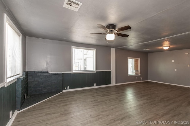 empty room with dark wood-type flooring and ceiling fan