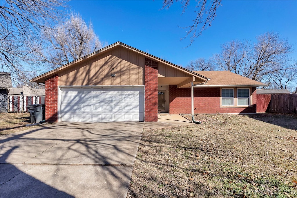 single story home with a front yard and a garage