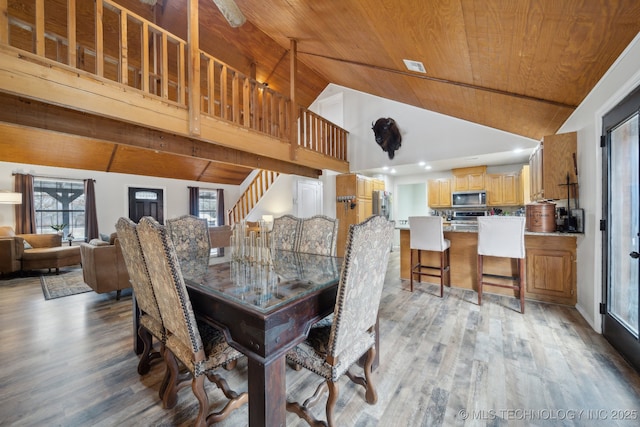 dining room featuring high vaulted ceiling, wood ceiling, and light wood-type flooring