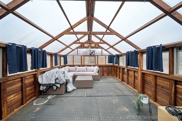 sunroom featuring vaulted ceiling