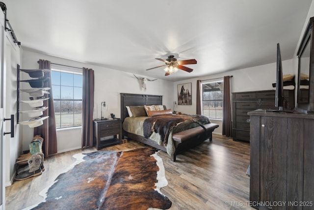 bedroom with ceiling fan and hardwood / wood-style flooring