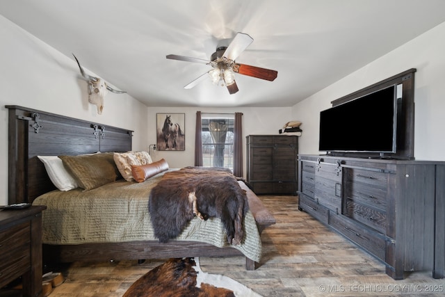 bedroom featuring ceiling fan and light hardwood / wood-style flooring