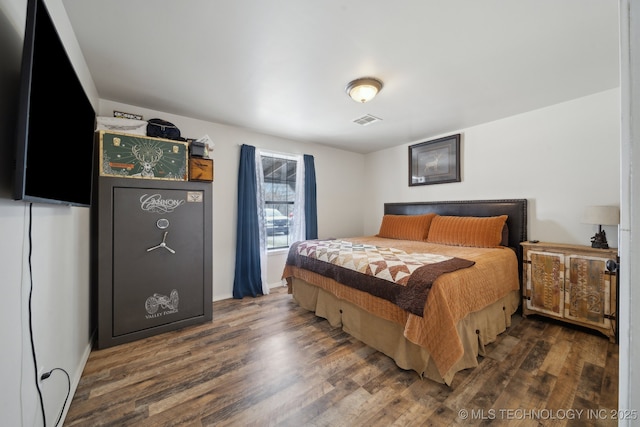 bedroom with dark hardwood / wood-style floors