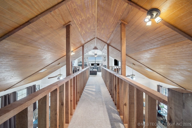 hall featuring carpet, wood ceiling, and lofted ceiling