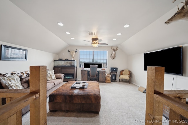 carpeted living room featuring ceiling fan and vaulted ceiling