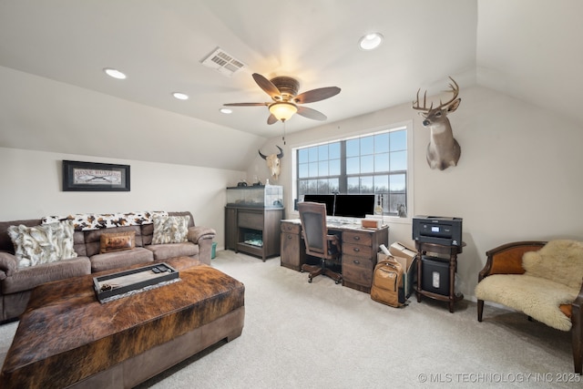 carpeted home office with vaulted ceiling and ceiling fan