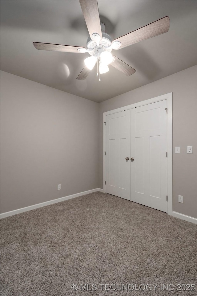 unfurnished bedroom with ceiling fan, a closet, and carpet flooring