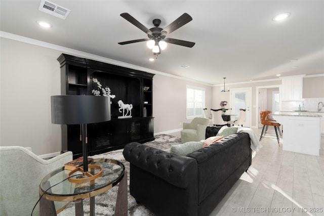 living room with ceiling fan, french doors, crown molding, and light hardwood / wood-style floors