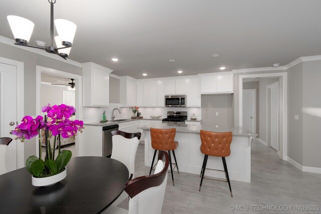 living room featuring ceiling fan, plenty of natural light, and crown molding