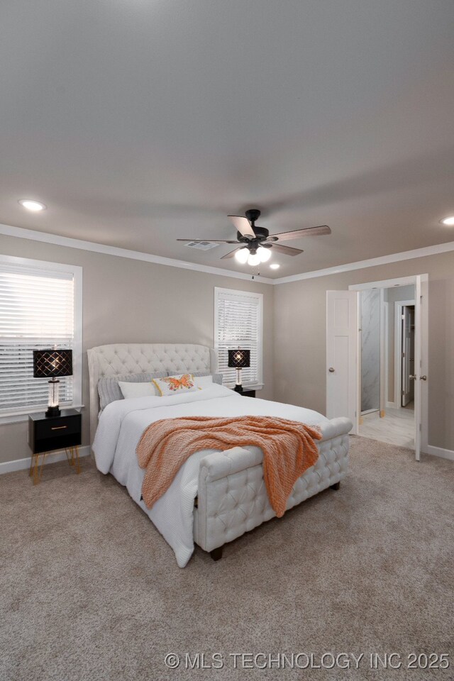 carpeted bedroom with ceiling fan and ornamental molding