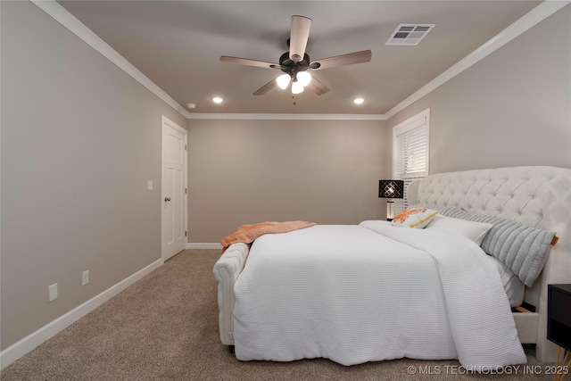 carpeted bedroom featuring ceiling fan and crown molding