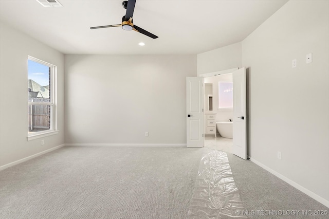 unfurnished bedroom with recessed lighting, light carpet, connected bathroom, and baseboards