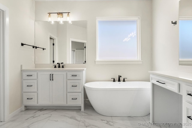 full bath with marble finish floor, a soaking tub, and vanity