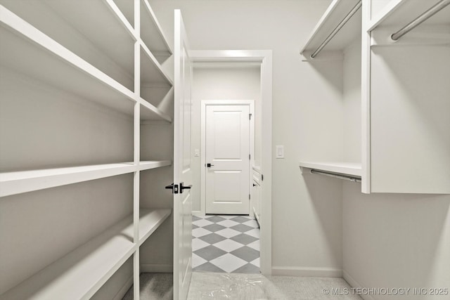 spacious closet featuring tile patterned floors