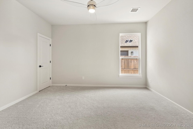 carpeted empty room with visible vents and baseboards