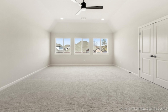 additional living space with vaulted ceiling, carpet flooring, visible vents, and baseboards