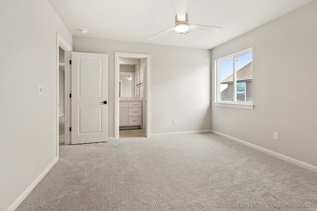 unfurnished bedroom featuring carpet floors, baseboards, and ensuite bathroom